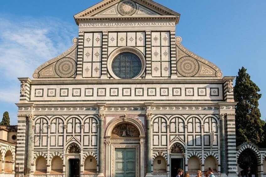 A historic building with intricate architectural details, including a large central dome and arched windows. 1