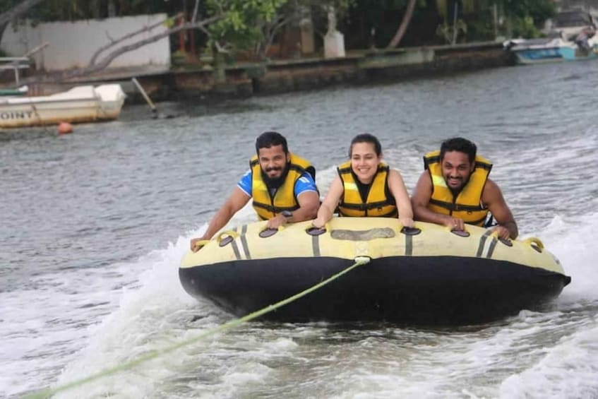 Three people in a yellow inflatable raft on a river. 5