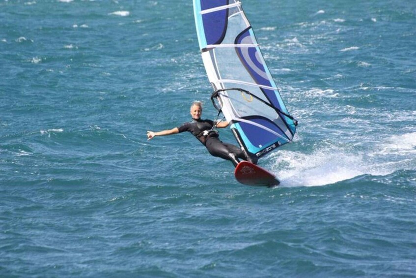 A person windsurfing on a body of water. 3