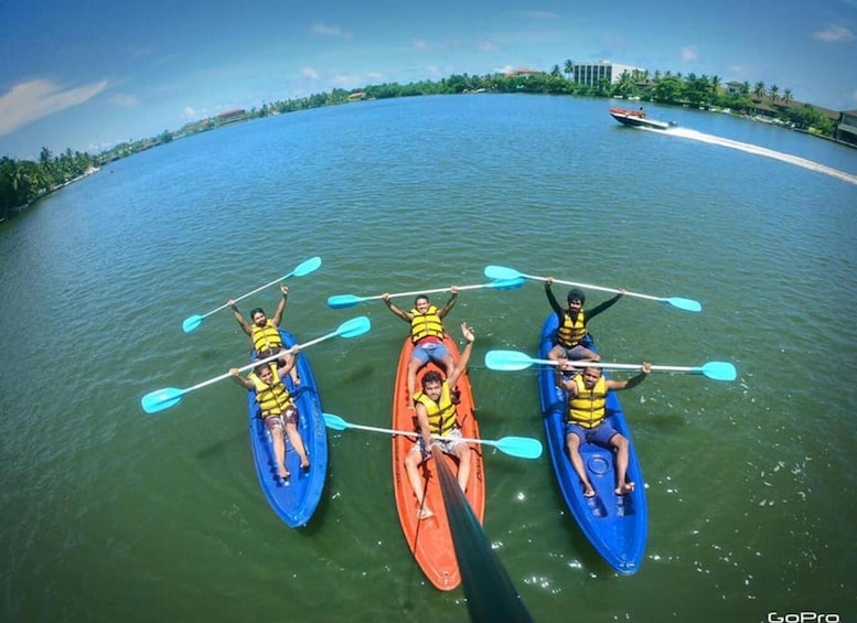Three kayaks on a calm body of water with a clear sky. 2