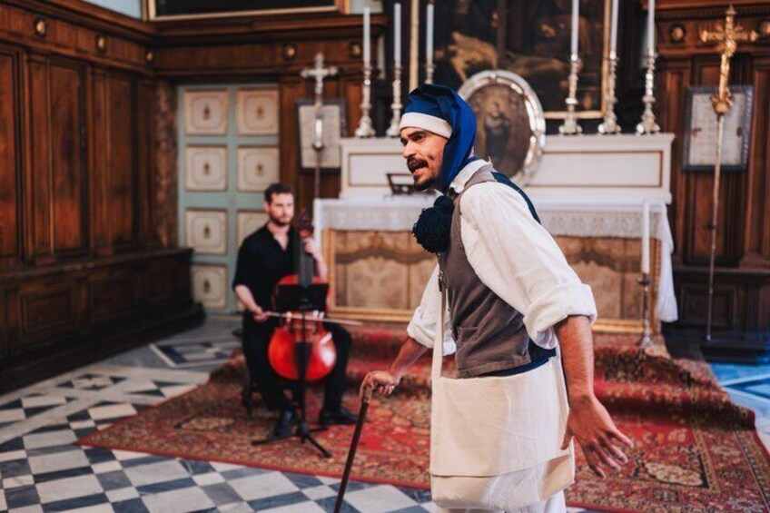 A person in historical attire with a double bass in a room with wooden paneling and a checkered floor. 5