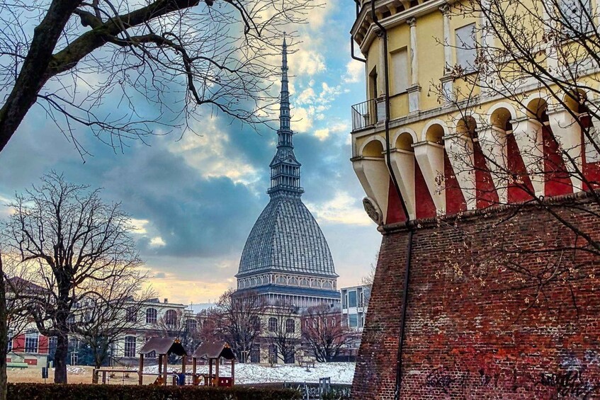 A snow-covered dome structure, a brick wall with red and white stripes, and a building with arched windows. 2
