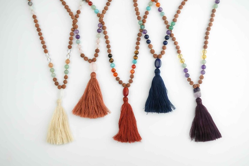 A collection of beaded necklaces with tassels. 1