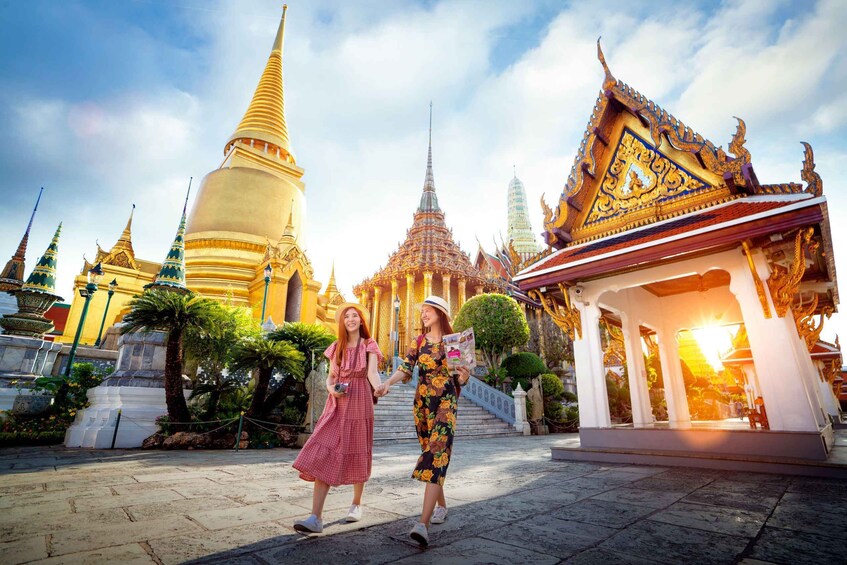 A temple complex with ornate architecture, including a large stupa and a smaller shrine with a golden roof. 3
