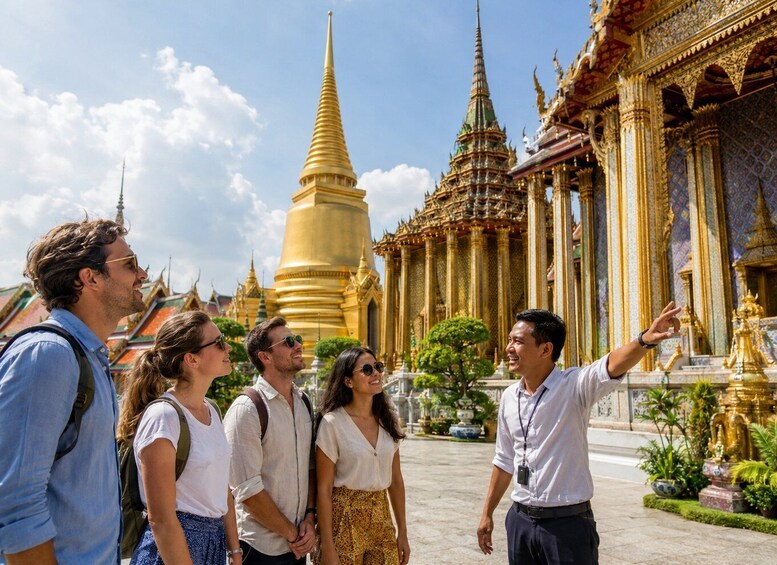 A group of tourists at a temple with golden spires and intricate architecture. 4