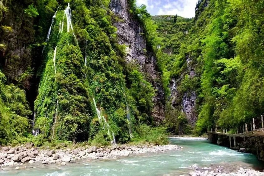 A river flowing through a canyon with waterfalls and lush greenery. 4