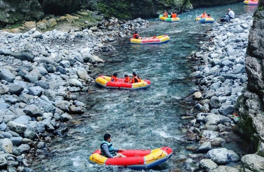 People rafting down a rocky river. 1