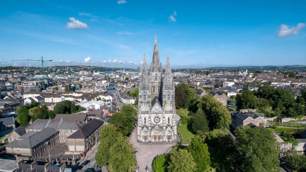 A cathedral with twin spires, surrounded by a cityscape and greenery. 5
