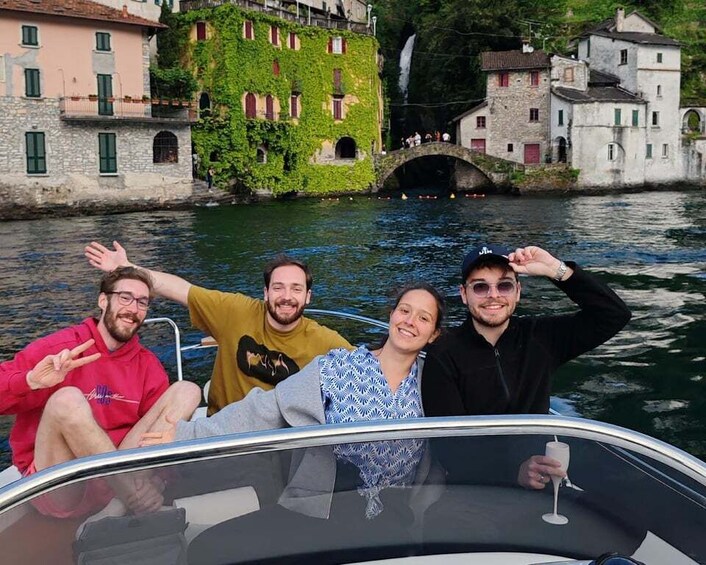 A group of people on a boat with a river and historic buildings in the background. 1