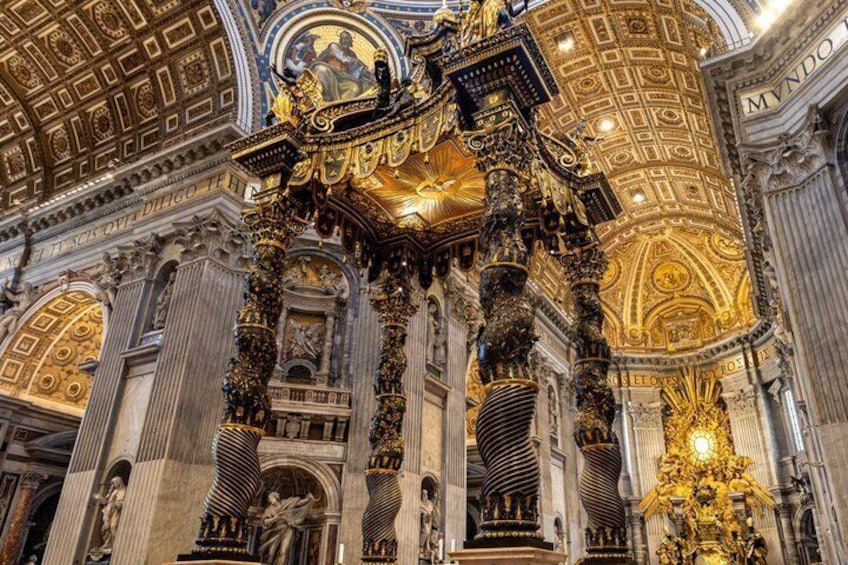 An ornate interior with golden accents, columns, and a detailed ceiling. 3