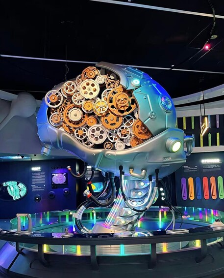 A large mechanical structure with gears and lights, surrounded by a circular platform with colorful lights. 5