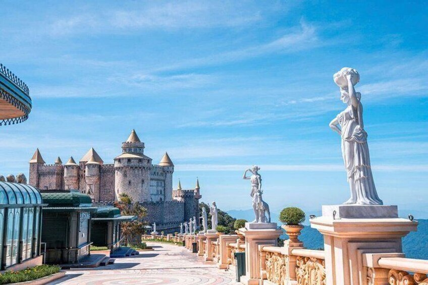 A castle, statues, and a clear blue sky. 4