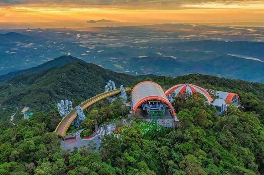 A mountain-top resort with a distinctive red and white building, surrounded by lush greenery. 2