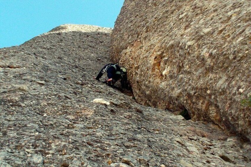 A person climbing a rocky slope. 3