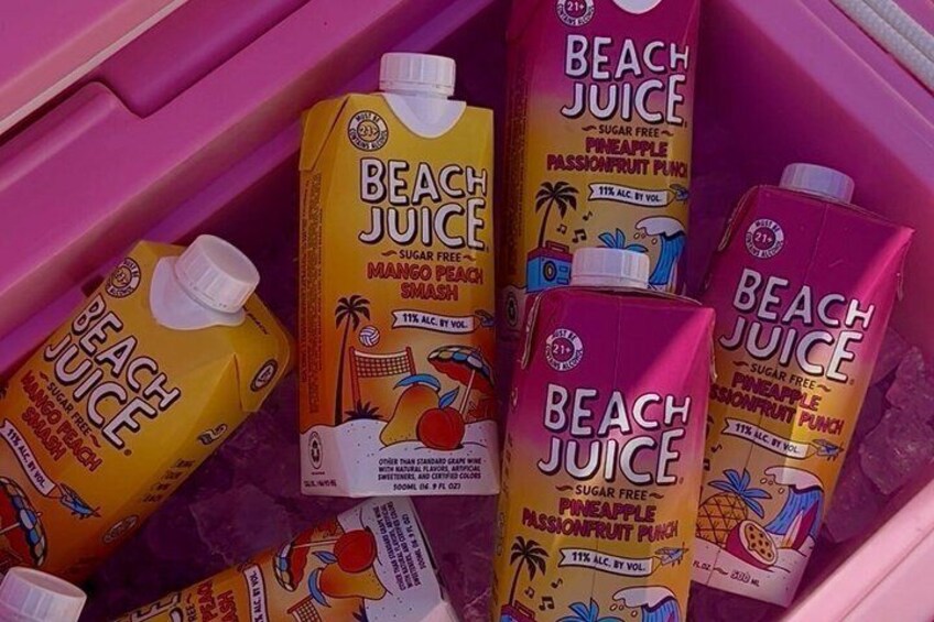 A pink cooler filled with various flavors of Beach Juice, including mango peach smash and pineapple passionfruit punch. 4