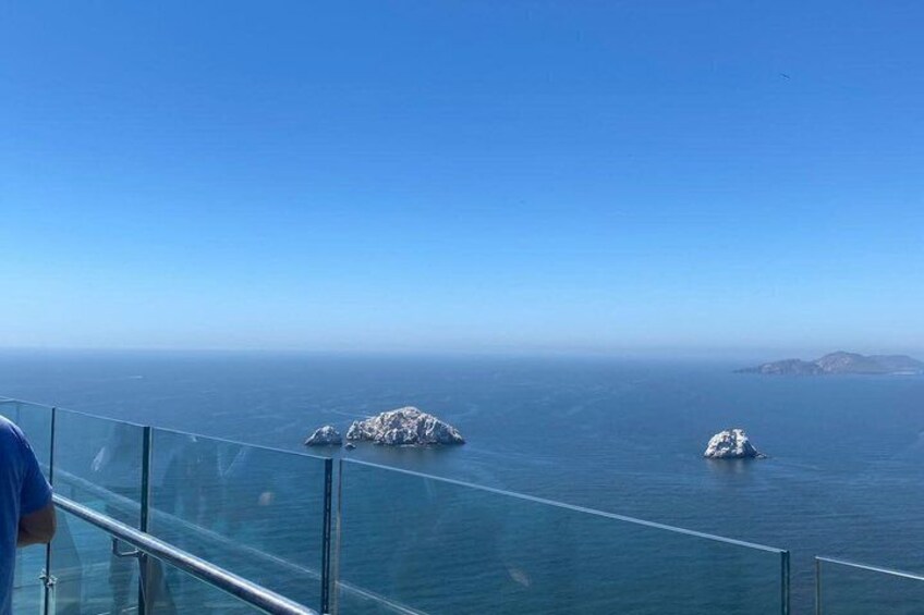 A clear view of the ocean with two small islands in the distance. 4