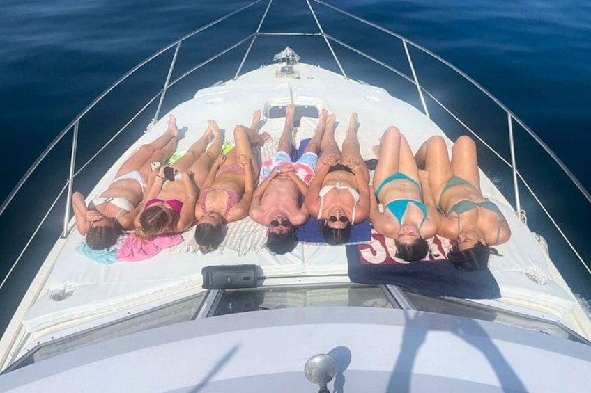 A group of people lying on a boat deck. 2