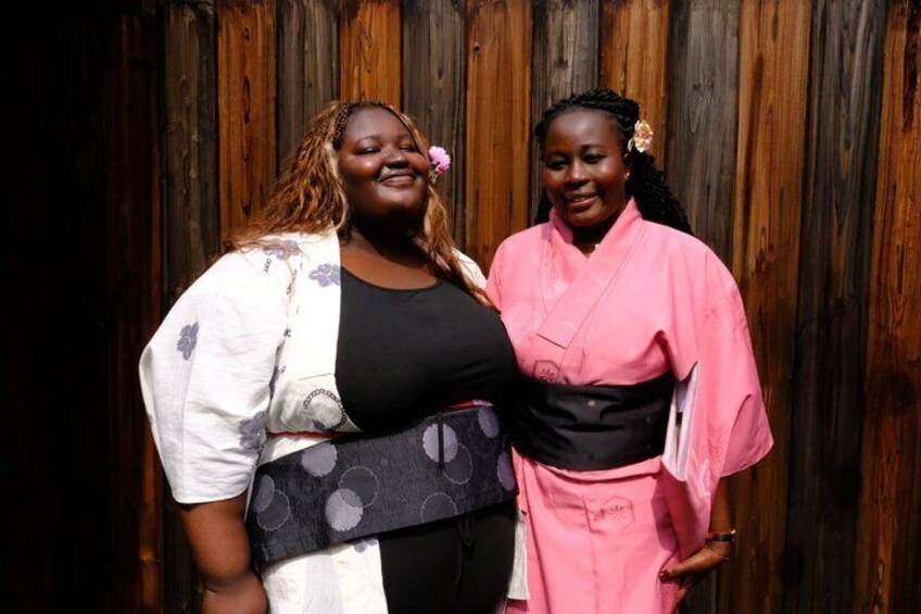 Two people standing in front of a wooden backdrop. 5