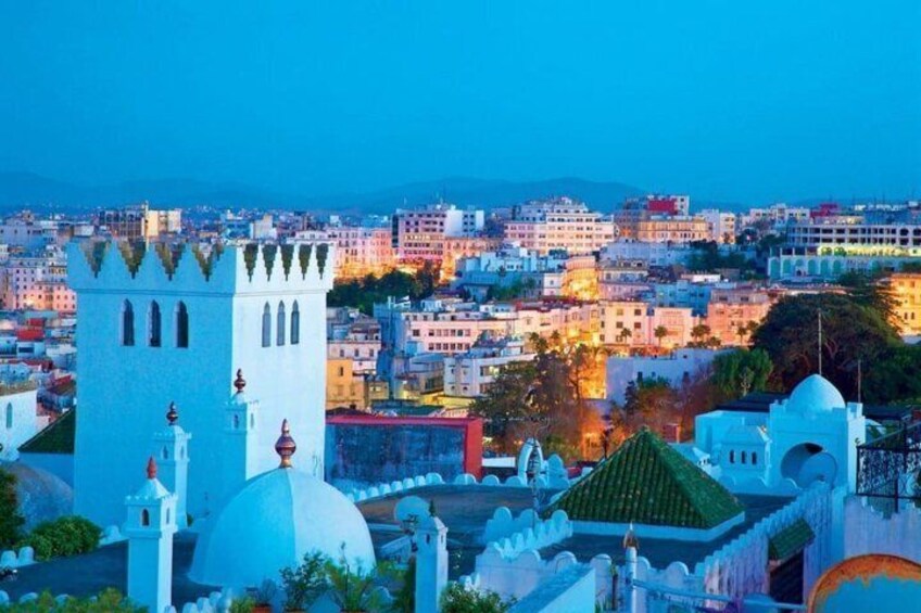 A cityscape with a prominent white tower, domed buildings, and a densely packed urban area. 3