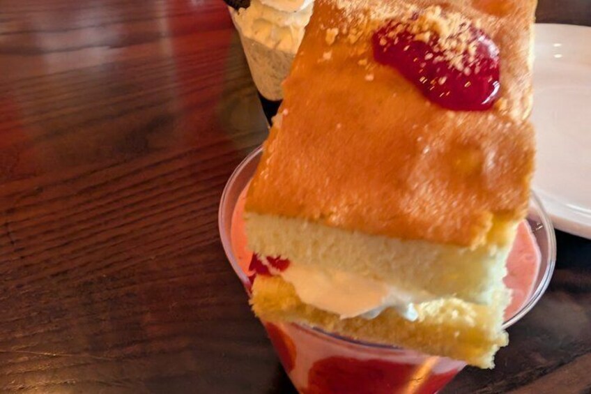 A slice of cake with whipped cream and a strawberry on top. 2