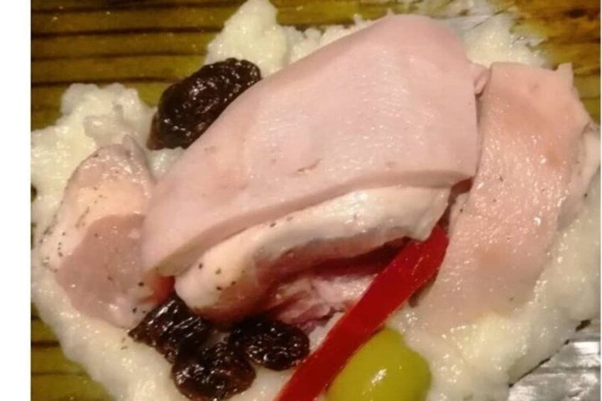 A dish with white rice, red bell pepper, and raisins. 2