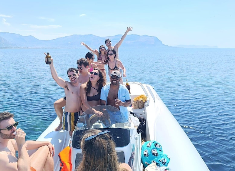 A group of people on a boat with mountains in the background. 3