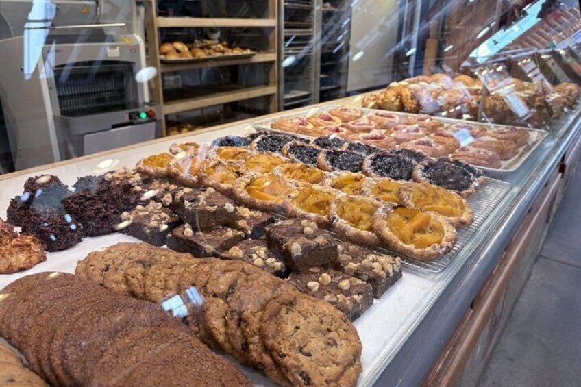 A bakery display case with various baked goods. 5
