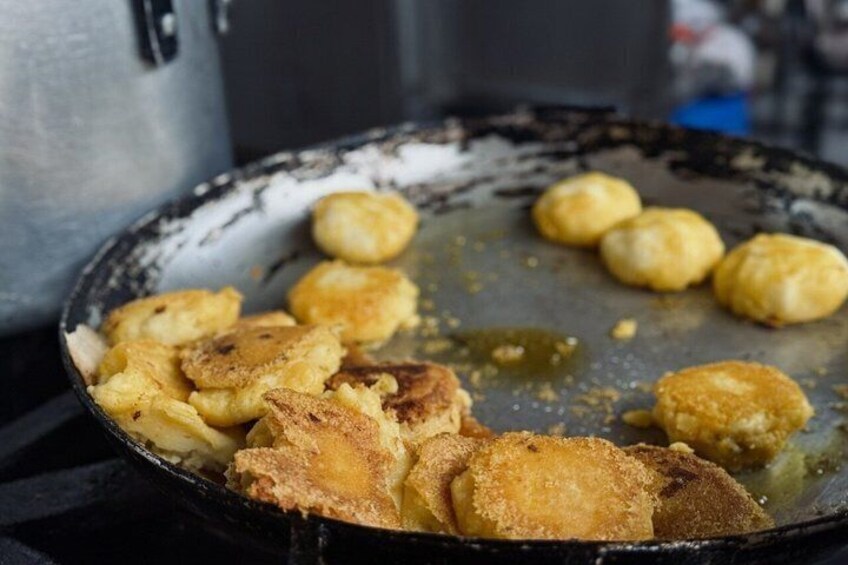 A frying pan with food items being cooked. 3