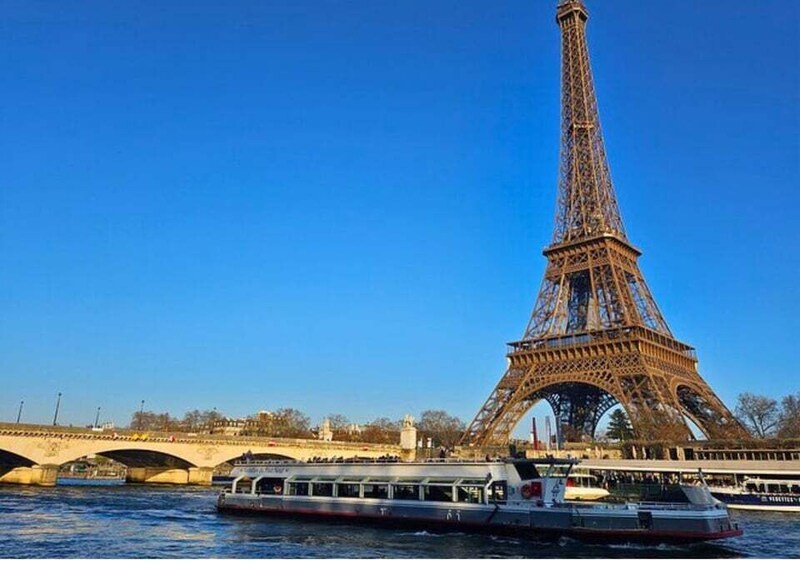 The Eiffel Tower with a riverboat in the foreground. 4