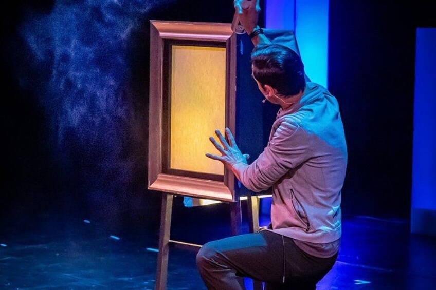 A person painting a canvas on an easel. 1