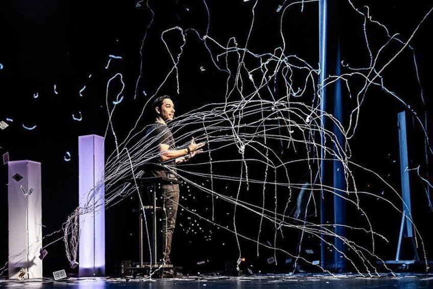 A person on stage with abstract light trails. 3