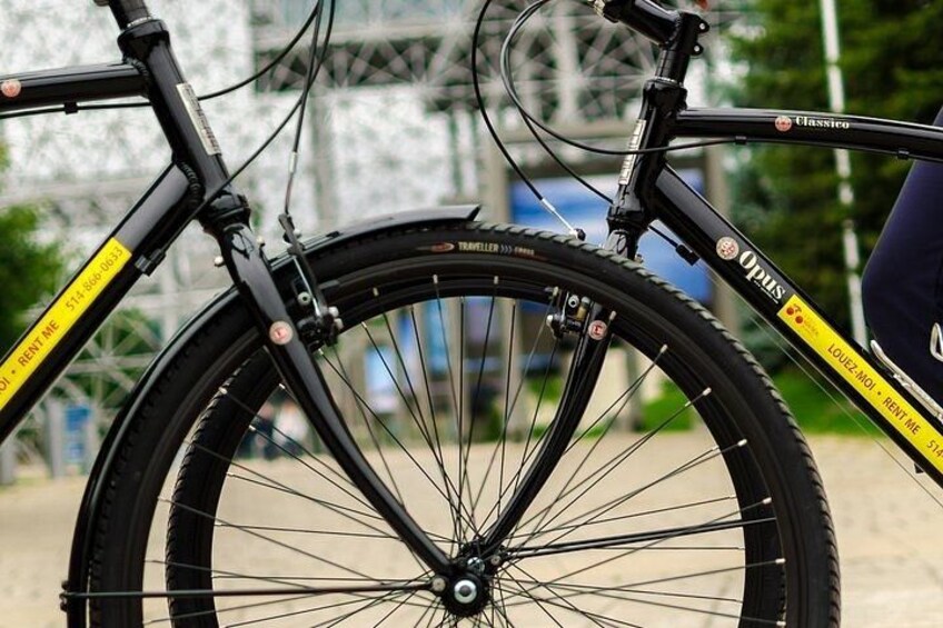 A bicycle with a black frame and yellow accents, a front wheel with a tire, and a chain. 2