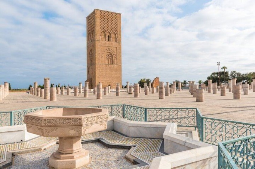 A historic tower, a fountain, and a patterned tiled area. 4