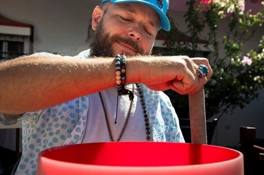 A person holding a red object, wearing a blue cap, and a patterned shirt. 5