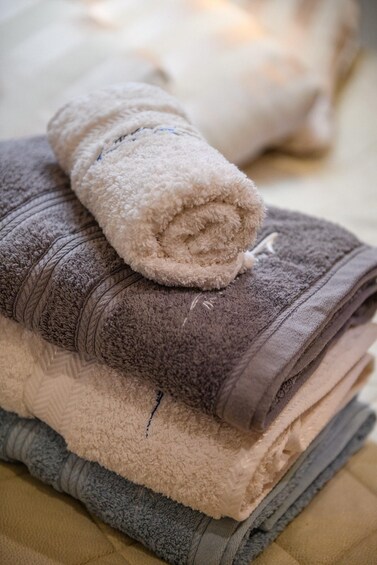 A stack of folded towels in various colors. 3