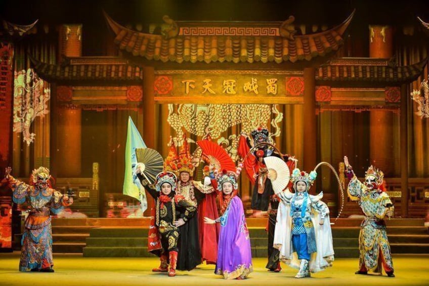 A traditional Chinese opera performance with actors in elaborate costumes and a stage with ornate architecture. 3