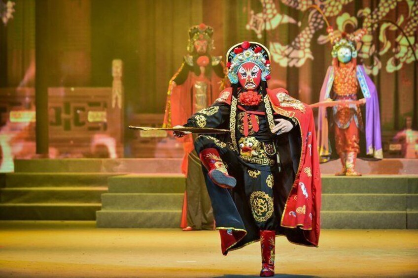 A performer in traditional Chinese opera costume on stage. 2