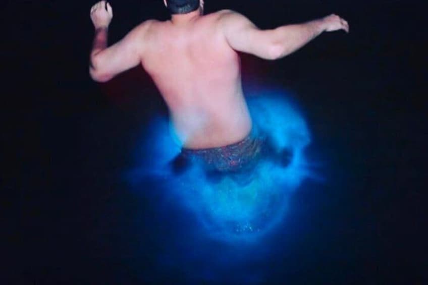 A person with arms outstretched, surrounded by a blue glow. 4