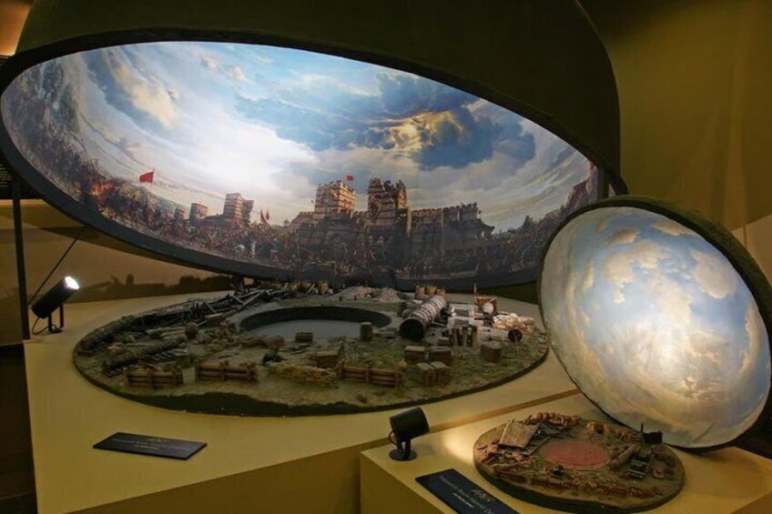 A model of a historical battle scene with a large globe and a detailed diorama. 3