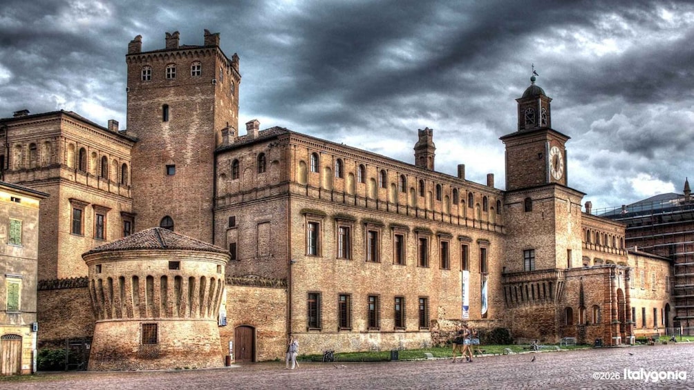 A historic building with a central tower, a dome, and a clock tower. 2