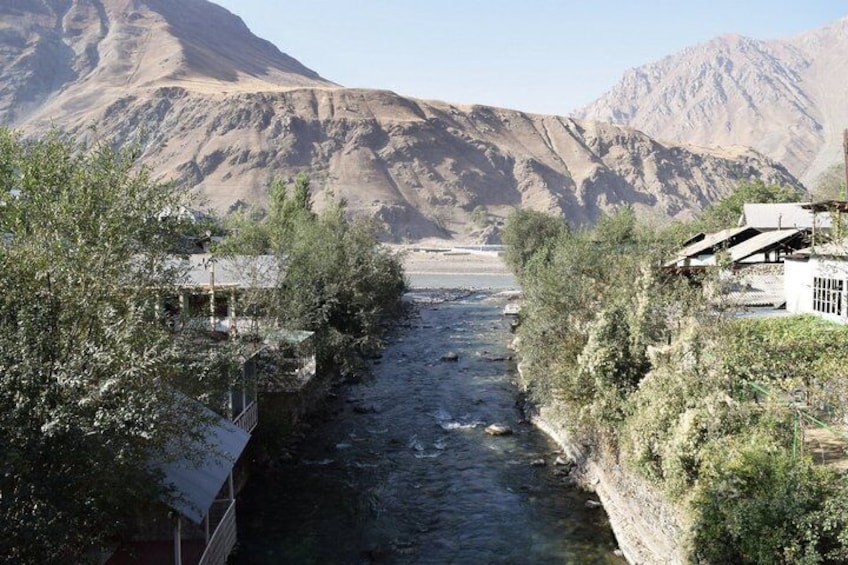 A river flowing through a canyon with buildings on the banks. 2