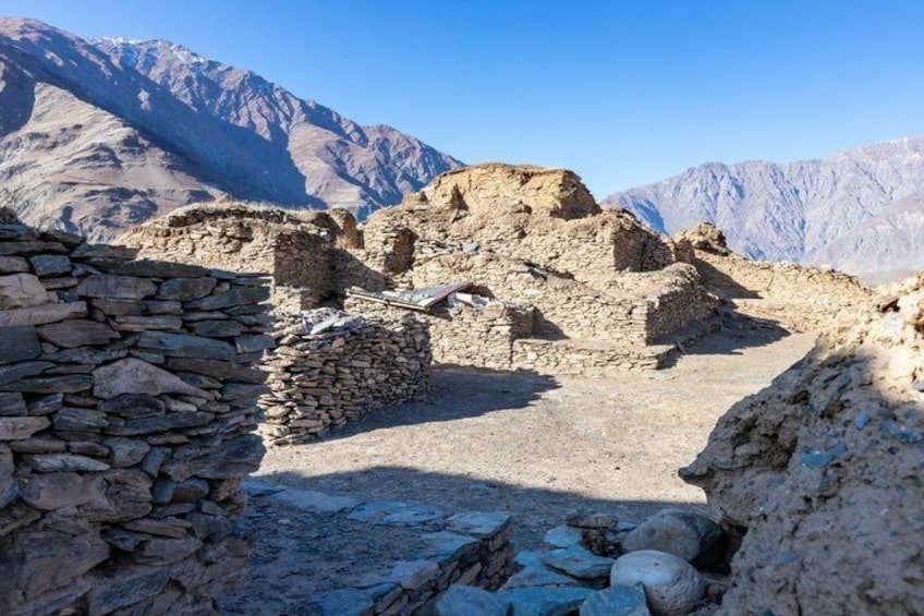 Ancient stone ruins with mountains in the background. 3