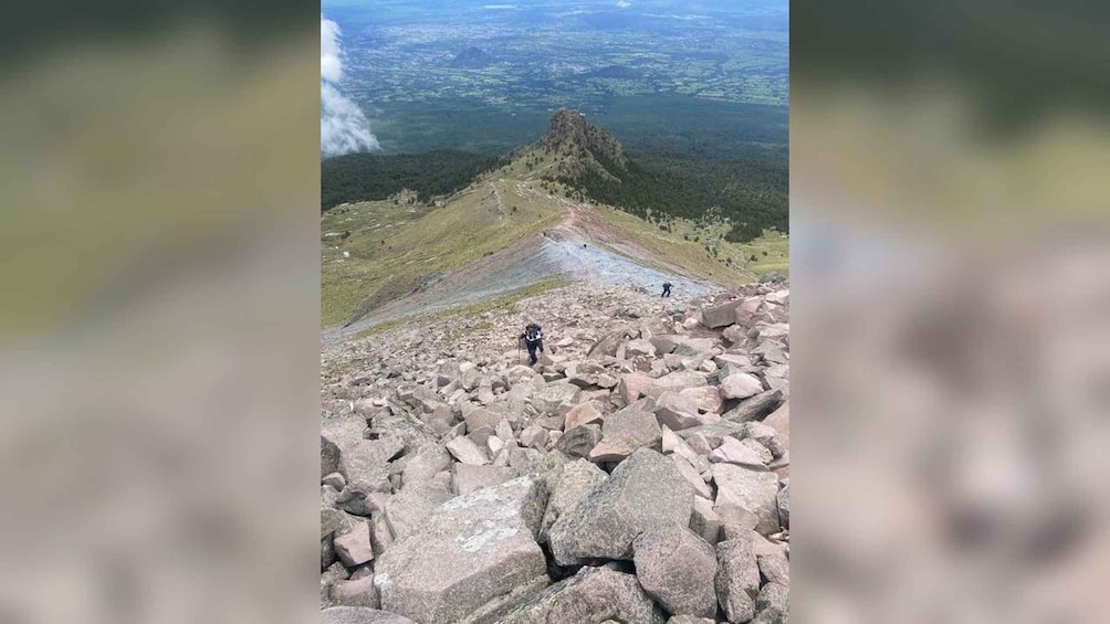 A rocky mountain peak with hikers. 2
