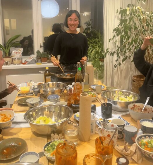 A dining table with various dishes and a bottle of sauce. 5