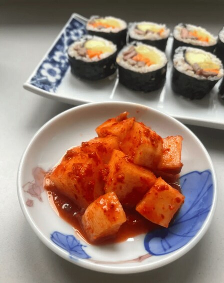 A plate of Korean kimchi and sushi. 4