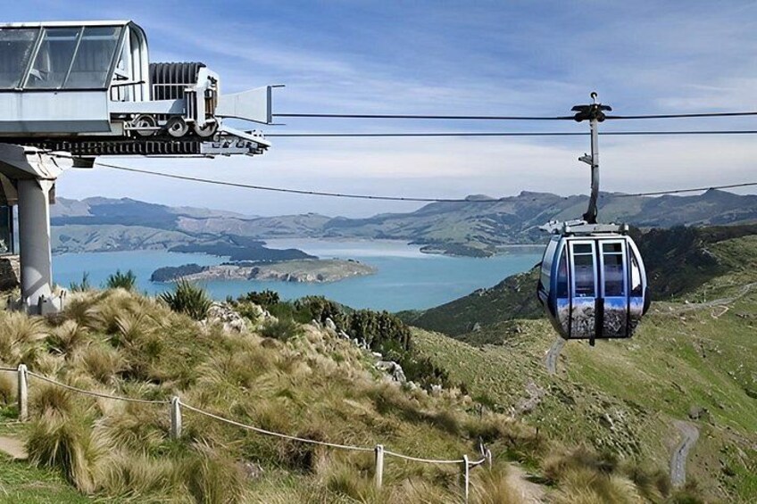 A cable car system, a mountainous landscape, and a body of water. 3