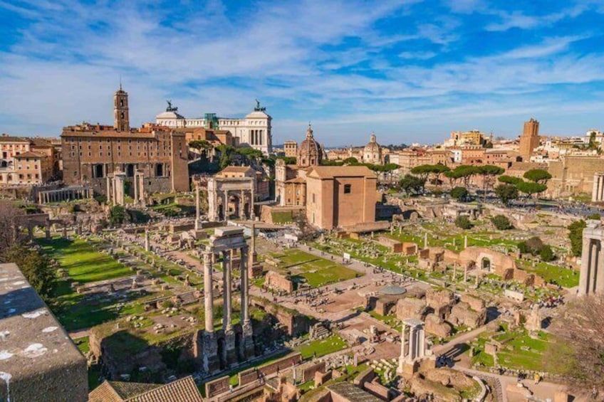 Ancient ruins, a large domed building, and a prominent tower in a historic cityscape. 1
