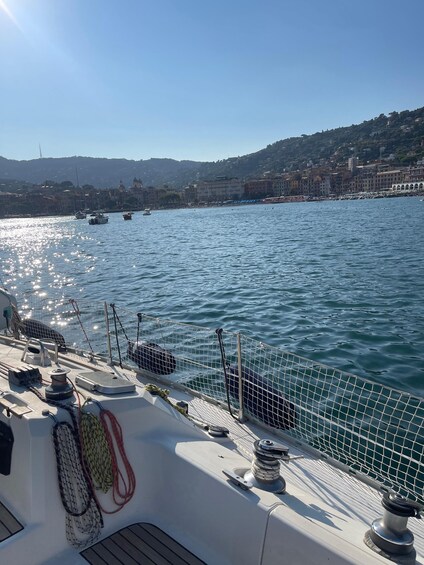 A boat docked near a waterfront with buildings in the background. 2