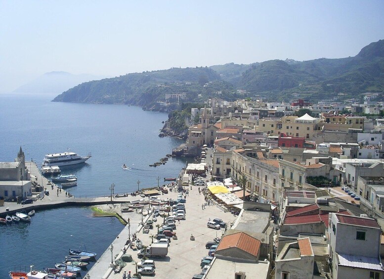 A coastal town with a marina, boats, and buildings along the waterfront. 2