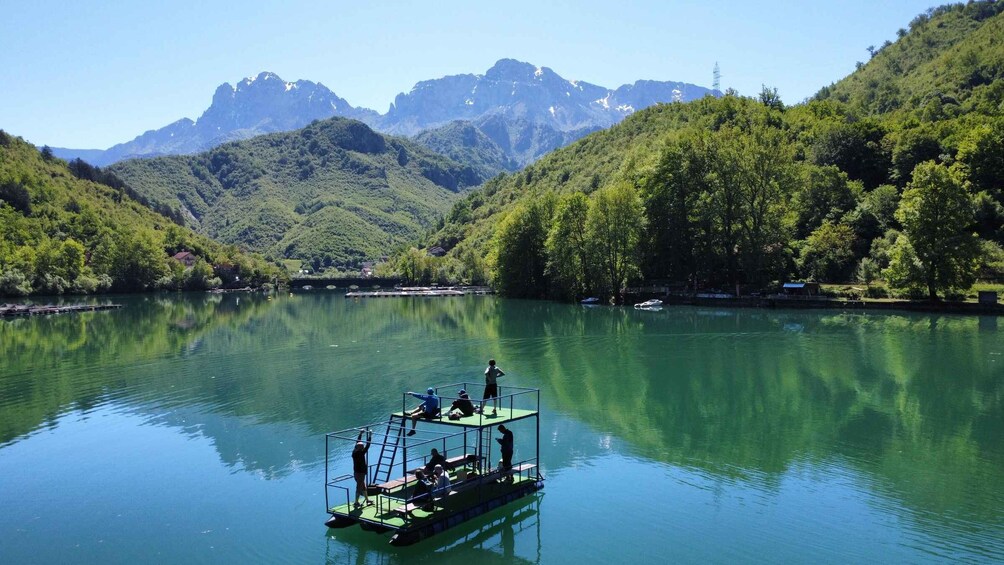 A boat on a calm lake with mountains in the background. 5